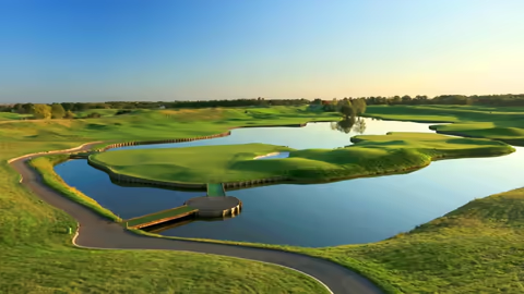 Scenic view of a lush golf course at the prestigious Golf Club of the World in France, surrounded by vibrant greenery.