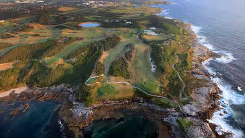 Scenic view of oceania golf course, showcasing lush greens and stunning coastal landscapes.
