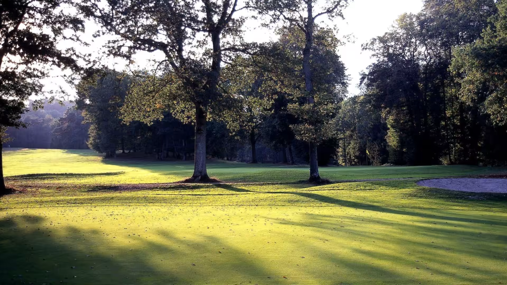 A golfer on the fairways of rochefort course at ugolf chateau de rochefort, surrounded by the stunning landscape of ile de france, france