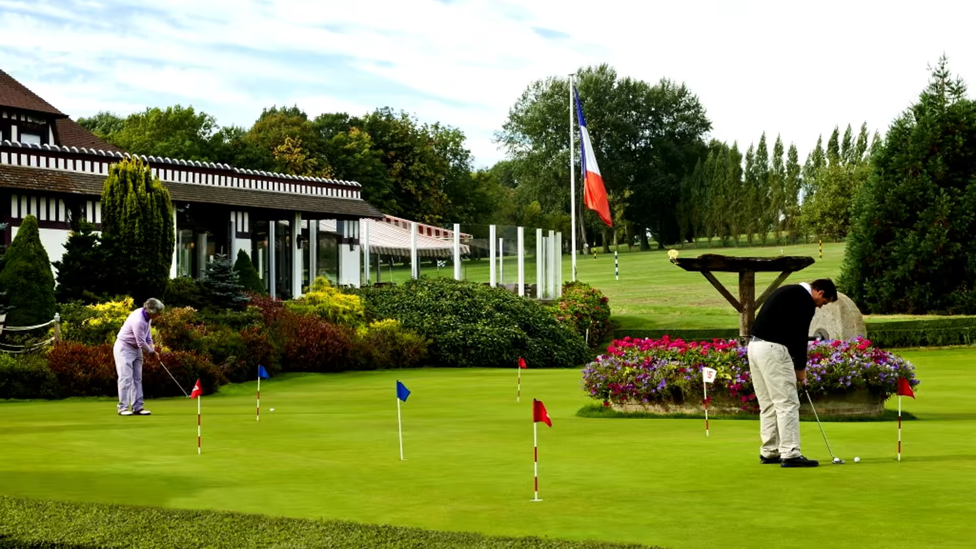 A golfer on the fairways of diane barriere course at golf barriere deauville, surrounded by the stunning landscape of normandie, france