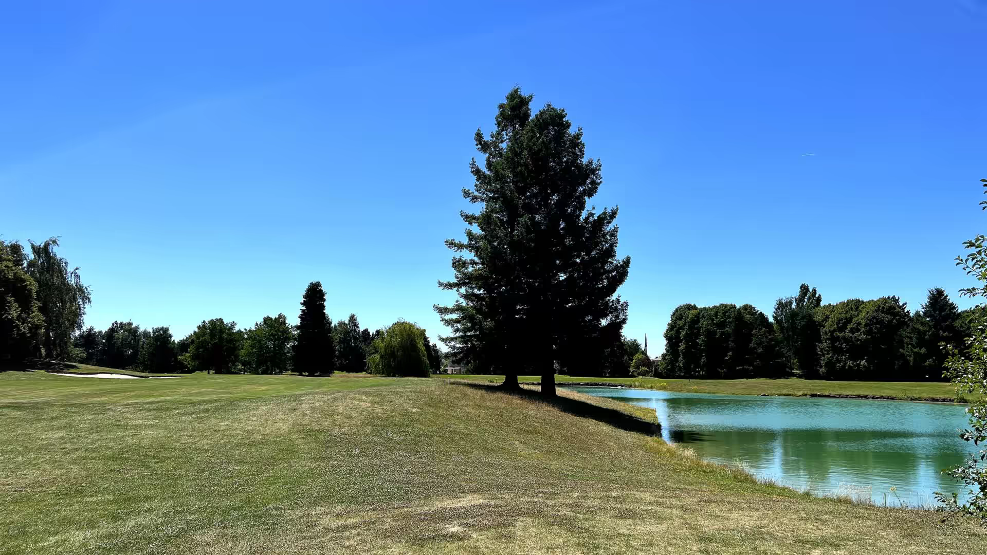 A golfer on the fairways of la jonchere course at golf de bussy guermantes marne la vallee, surrounded by the stunning landscape of ile de france, france